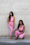 Two models wearing Aura 7 Activewear Flower Vita Legging yoga pants posing in front of brick wall on the street